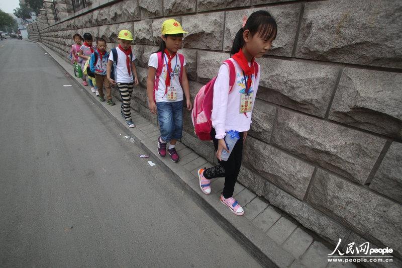2013年09月11日，濟南運署街上，小學生走史上“最窄人行道”上學。圖片來源：CFP