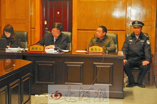 庭審現場，被告人坐在律師身旁為自己辯護。