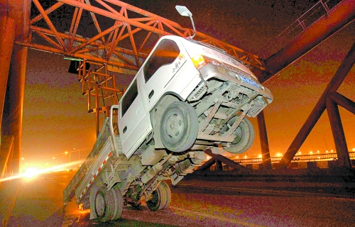 　車上升降機的工作臺被卡，車身前部高高翹起。