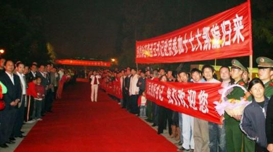 “夾道歡迎”中不少人打出橫幅，路上被鋪上了紅毯。
